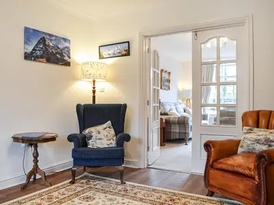 a living room with a chair and a table at Parkfield in Keswick