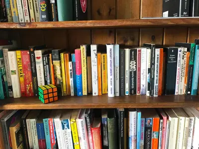 a book shelf filled with lots of books at Grand top floor apartment in the Royal Bank House in Maybole