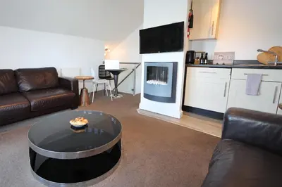 a living room with a couch and a table at The Inn on the Loch in Castle Douglas