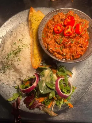 a plate of food with rice and a bowl of food at The Inn on the Loch in Castle Douglas