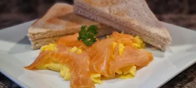 a plate of food with salmon and bread on it at Glencoe Guest House in Keswick
