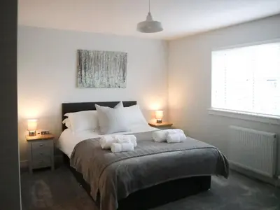 a bedroom with a bed with two towels on it at 4 Mote View-Uk37497 in Sandhead
