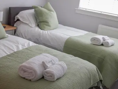 two towels on two beds in a room at 4 Mote View-Uk37497 in Sandhead