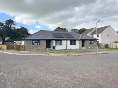 a brick house with a black roof on a street at 2 Mote View- Uk37496 in Sandhead