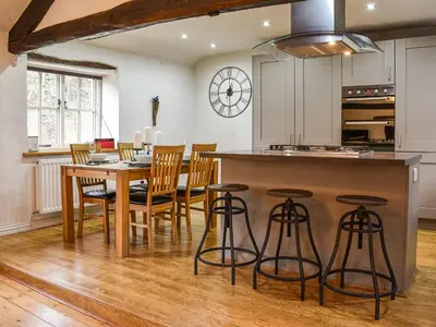 a kitchen and dining room with a table and chairs at Forge Cottage in Keswick