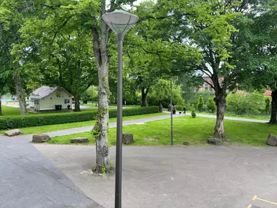 a street light next to a tree in a park at River View in Dumfries