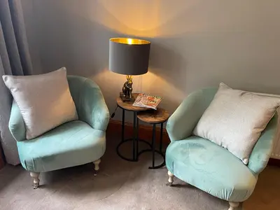 a room with two chairs and a table with a lamp at River View in Dumfries