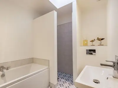 a bathroom with a white tub and a sink at Brooksyde,Kippford in Kippford