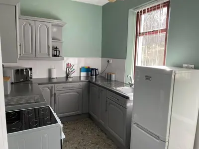 a kitchen with white appliances and a white refrigerator at Rowan Cottage Wanlockhead Dumfries & Galloway in Wanlockhead