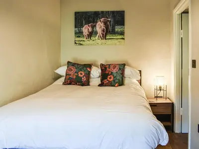 a bedroom with a white bed with two pillows at Wallthwaite Cottage in Threlkeld