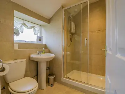 a bathroom with a toilet sink and a shower at The Old Mill in Keswick