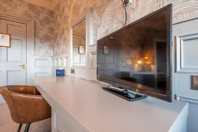 a large flat screen tv sitting on top of a counter at Enterkine Country House Resort in Annbank