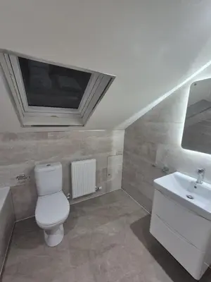a bathroom with a toilet and a sink and a tv at The Prestwick Pad in Prestwick
