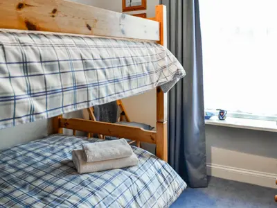 a bunk bed with a pillow on the bottom bunk at Sinclair's in Gatehouse of Fleet