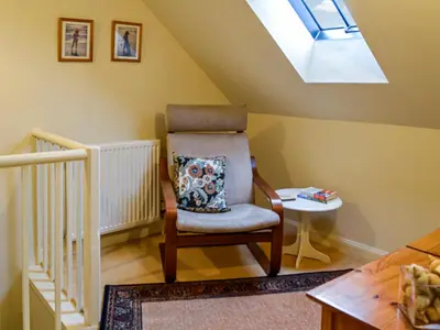 a chair in a room with a skylight at Sinclair's in Gatehouse of Fleet