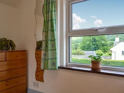 a window in a room with a plant on a window sill at Fell View in Lorton