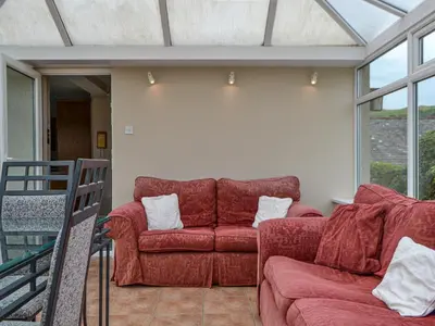 a living room with a red couch and windows at Fell View in Lorton