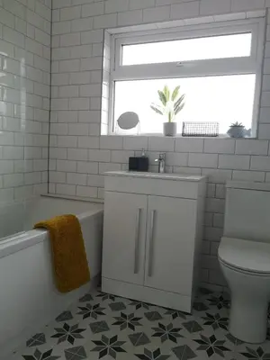 a bathroom with a sink and a toilet and a window at The Mila - Ayr Racecourse - Coorie Doon Stays in Ayr