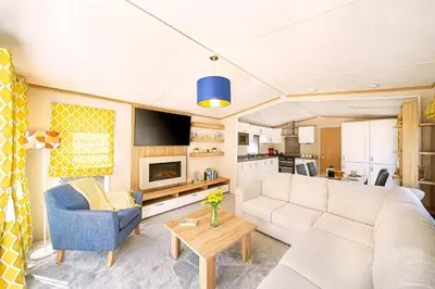 a living room with a couch and a table at Discover, Enjoy Ultra-Fast Starlink WiFi Lodge in Carlisle