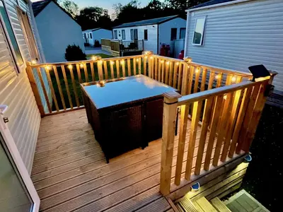 a wooden deck with a heater and lights on it at Discover, Enjoy Ultra-Fast Starlink WiFi Lodge in Carlisle