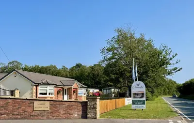 a house with a sign in front of it at Discover, Enjoy Ultra-Fast Starlink WiFi Lodge in Carlisle
