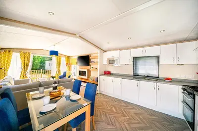 a kitchen and living room with a couch and a table at Discover, Enjoy Ultra-Fast Starlink WiFi Lodge in Carlisle