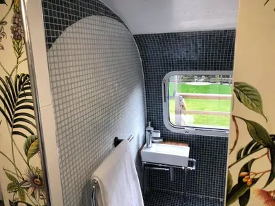 a bathroom with a sink and a window at Ayrshire Airstream in Galston