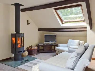 a living room with a fireplace and a couch at The Mill in Mungrisdale
