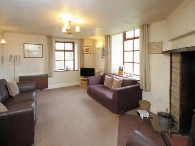 a living room with a couch and a fireplace at The Coach House - Uk38000 in Kirkcowan
