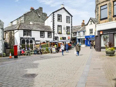 a street in a town with people walking down the street at The Old Stable in Keswick