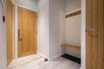 a hallway with a wooden door and a wooden floor at Howe Keld 6 Second Floor in Keswick