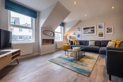 a living room with a couch and a tv at Howe Keld 6 Second Floor in Keswick