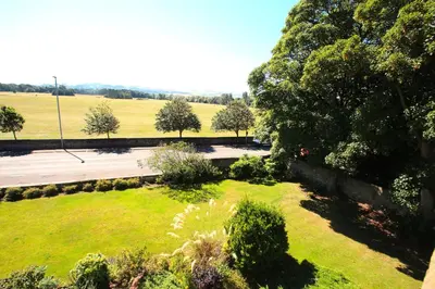 an aerial view of a park with trees and a road at Beautiful 2 to 3 bed apartment with stunning views! in Ayr