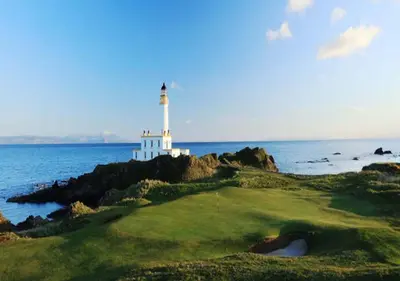 a lighthouse on a golf course with the ocean and a lighthouse at Beautiful 2 to 3 bed apartment with stunning views! in Ayr