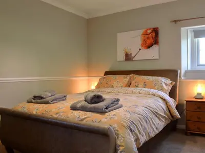 a bedroom with a bed with towels on it at Fieldside Farmhouse in Tallentire
