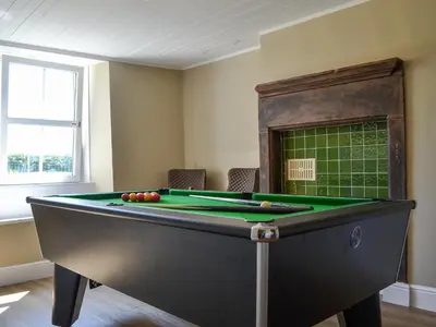 a room with a pool table with balls on it at Fieldside Farmhouse in Tallentire