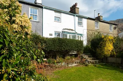 a house with a garden in front of it at Rhubarb Cottage in Chapel Stile