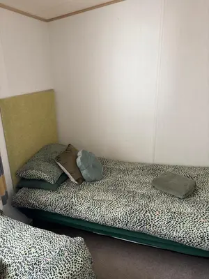 two beds sitting next to each other in a room at Squirrel Lodge (Unit 7) in Carlisle
