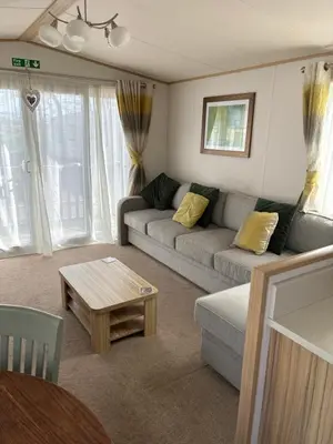a living room with a couch and a coffee table at Squirrel Lodge (Unit 7) in Carlisle