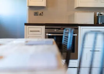 a kitchen with a stove and a counter top at Gatesgarth Cottage @ The Pheasant Inn in Brampton