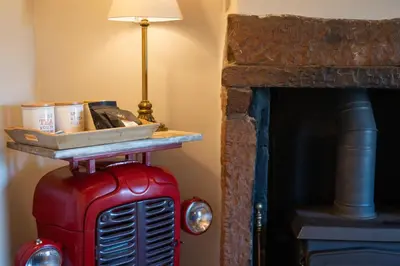 a room with a table on top of a red fire truck at Gatesgarth Cottage @ The Pheasant Inn in Brampton