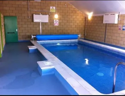 a large swimming pool in a building at Carnoustie 24 - Turnberry Holiday Park - short walk to beach in Girvan