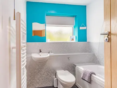 a bathroom with a white toilet and a sink at Fairview in Keswick