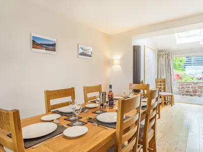 a dining room with a wooden table and chairs at Fairview in Keswick