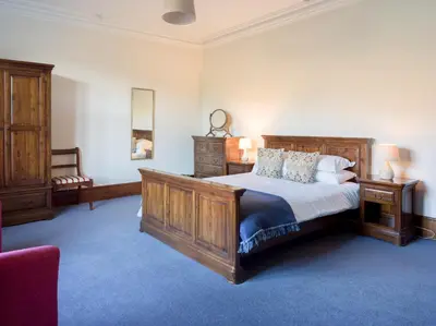 a bedroom with a large bed and two night stands at Yewthwaite Newlands Keswick in Keswick
