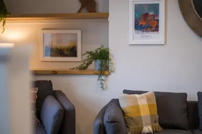 a living room with two brown couches in a room at Howe Keld 4 First floor in Keswick