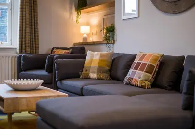 a living room with two couches and a table at Howe Keld 4 First floor in Keswick