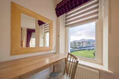 a window in a room with a desk and a mirror at Howe Keld 4 First floor in Keswick