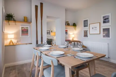 a dining room with a wooden table and chairs at Howe Keld 5 First Floor in Keswick