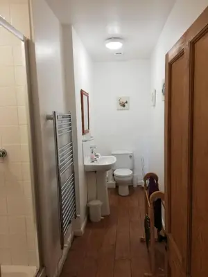 a bathroom with a toilet and a sink at Rainors farm B&B in Gosforth